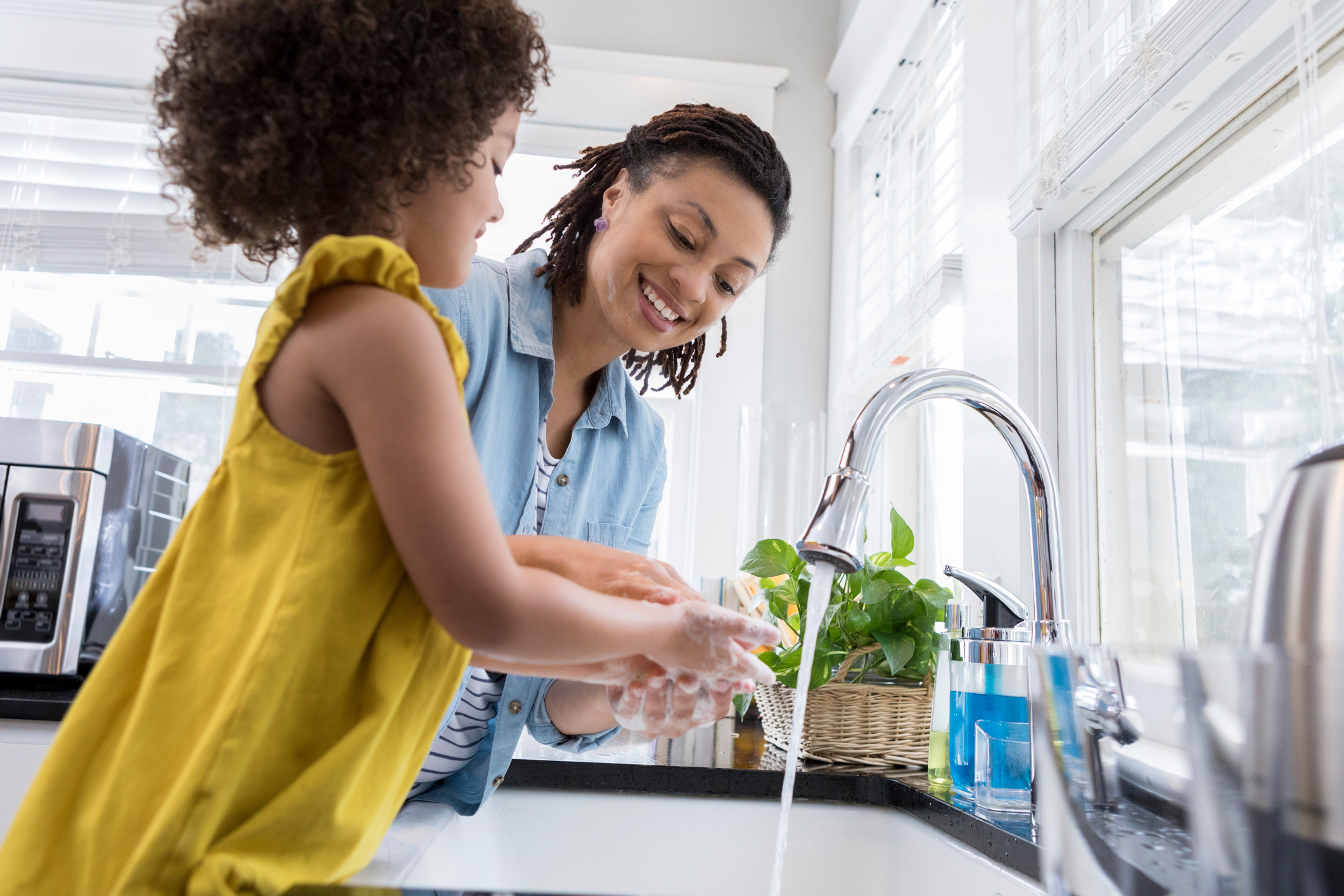 Mom Helping Young Daughter Wash Hands