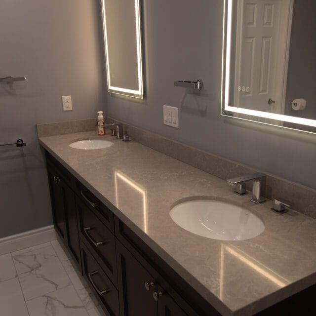 Double vanity with two sinks and lit mirrors