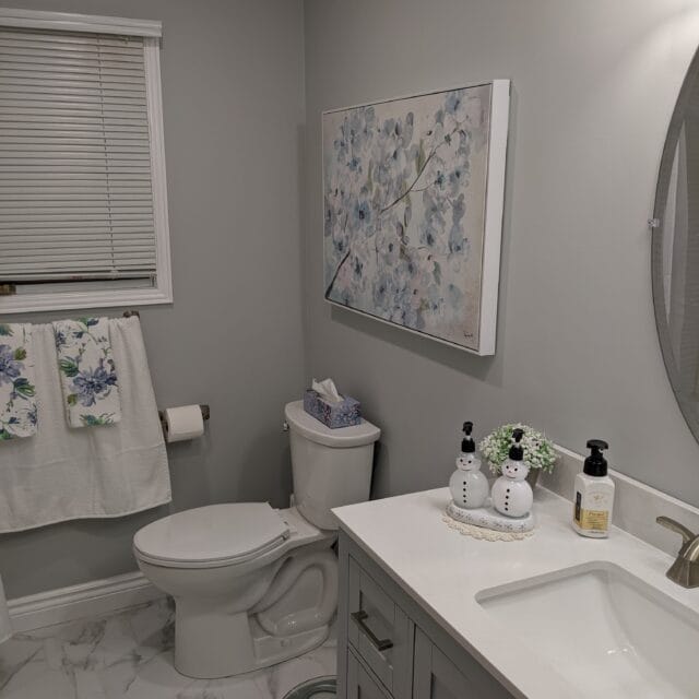 Toilet and vanity in a grey renovated bathroom