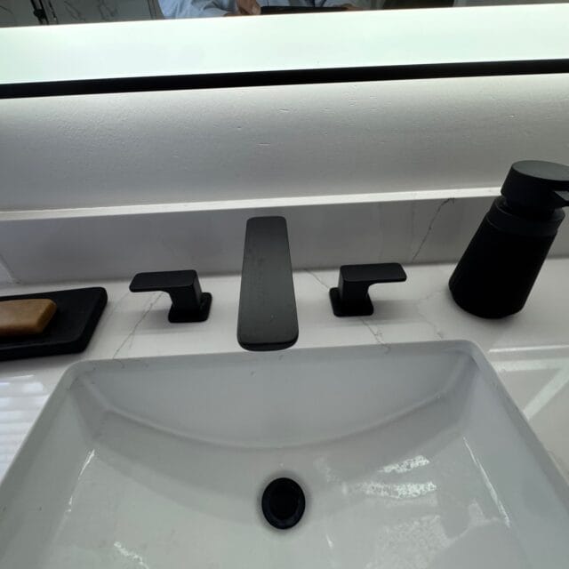 Undermount sink with a black widespread faucet