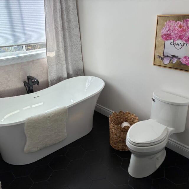 Freestanding soaker tub and toilet in a renovated bathroom